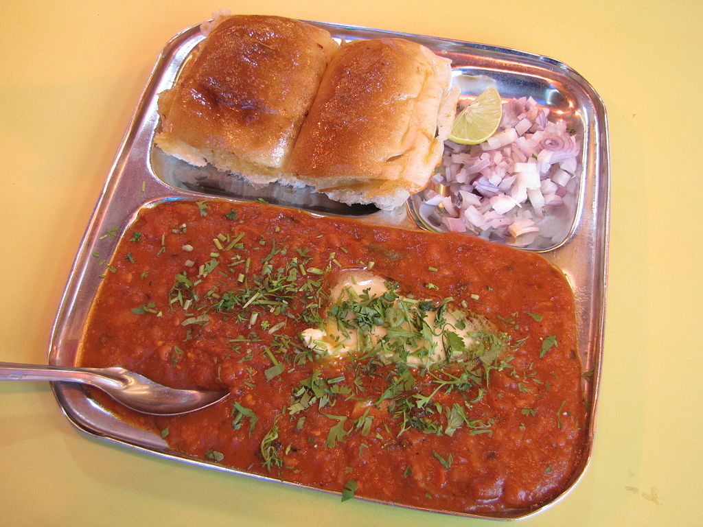 An image of this dish Pav Bhaji served with raw onion and chutneys